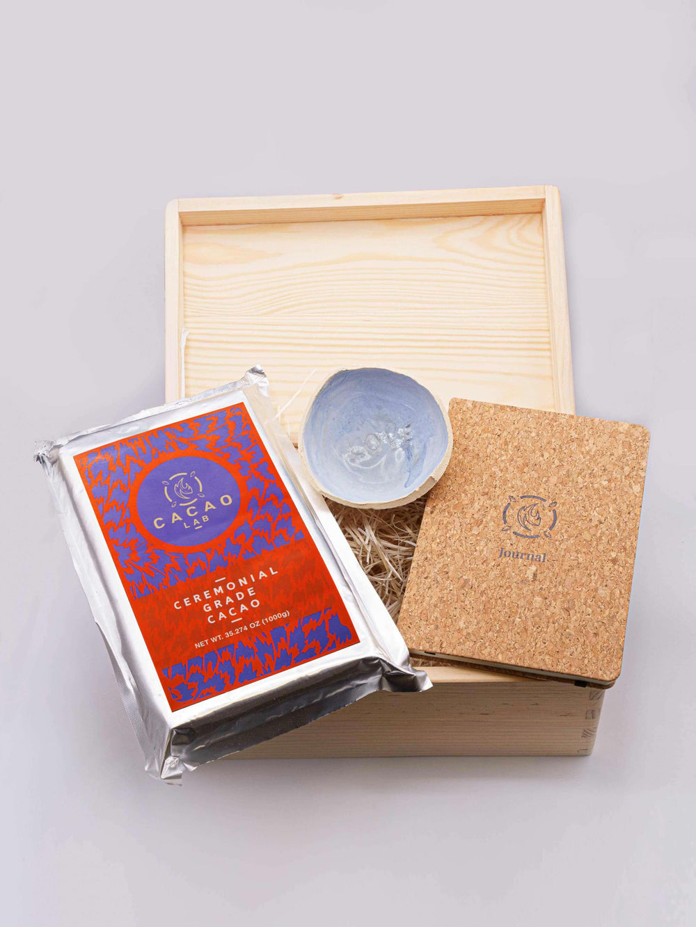 Cacao dieta box with ceremonial cacao, clay bowl, and cacao meditation journal
